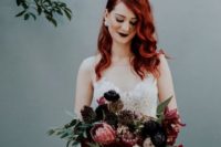 26 red hair and a very dark burgundy lip make a bold statement, while a romantic wedding dress softens the look