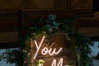 26 such a small wedding neon sign spruced up with greenery is a cool and modern idea for the wedding reception