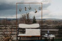 a celestial wedding lounger with stars and moons, a loveseat, dried flowers and branches, candles and layered rugs