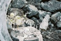 a grey celestial wedding tablescape with a grey half moon, candles and blooms is adorable