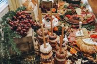 a luxurious multi-layer grazing table with charcuterie, cheese, fruits, berries, bread in a box and glazed donuts on stands