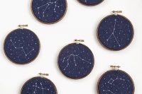 embroidery hoops with navy fabric and embroidered constellations as favors