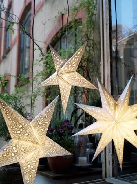 hang some lit up stars as lamps and lights to make your reception or ceremony space cozier and cooler