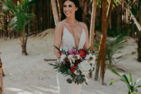 02 The bride chose a wonderful sheath embellished wedding dress with a plunging neckline and a train, waves and statement earrings