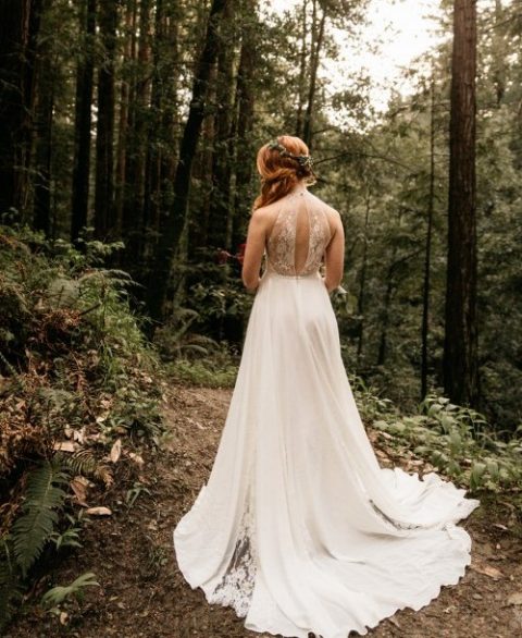 a beautiful A-line wedding gown with a lace illusion back with a cutout and a plain skirt with lace inserts
