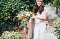 02 a boho 70s inspired bridal look with a lace crop top, fringe and short sleeves and plain fit and flare pants