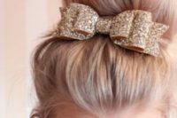 02 a large top knot highlighted with a gold glitter ribbon and a bow on top looks timeless and very chic