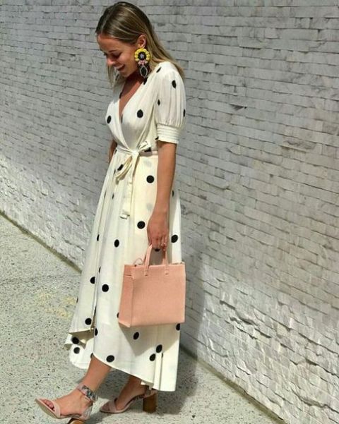 a creamy polka dot wrap mixi dress with short sleeves, blush printed shoes and a blush bag plus statement earrings