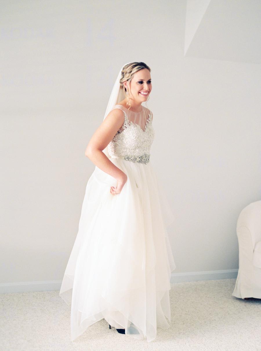 The bride was wearing a wedding separate of a lace top and a layered tulle skirt plus an embellished sash