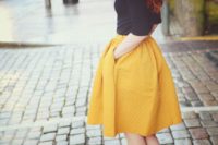05 a black turtleneck with short sleeves, a full marigold knee skirt, black heels for a bold and chic fall outfit