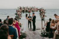 06 The wedding arch was done with pink, blush, white blooms and much tropical greenery, and the ocean was the backdrop