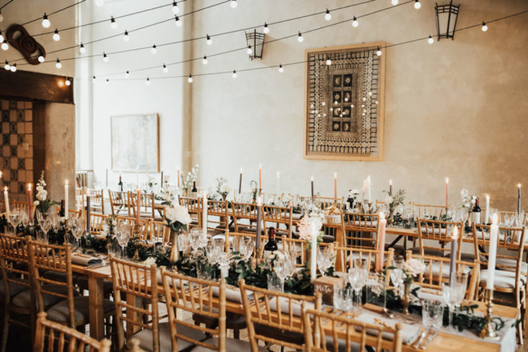 The wedding venue was all lit up, with lots of greenery and neutral blooms