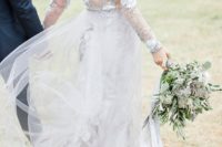 06 a dove grey wedding dress of lace, with long sleeves, a cutout back and a train for a slight touch of color