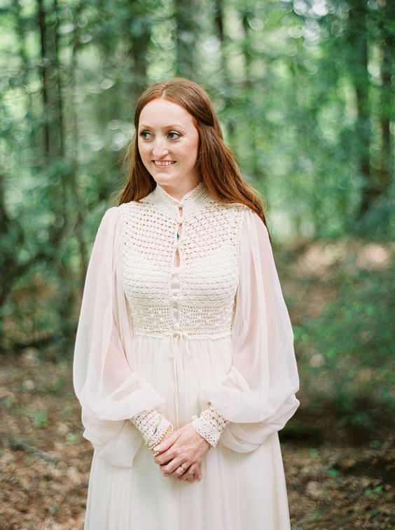 a 70s inspired boho wedding dress with puff sleeves, a crochet bodice, an illusion neckline