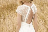 09 a boho wedding gown with a lace bodice and a cutout back on a button and a plain A-line skirt and a hat for a boho bride