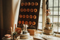 a wedding dessert table with a donut wall