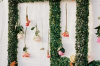 10 What a pretty wedding decoration of greenery frames with flowers hanging down