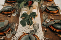 11 The wedding tablescapes were done with macrame runners, tropical leaves and greenery, copper and grey plates and grey glasses