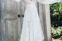 11 a boho lace and plain A-line wedding dress with bell sleeves, a high low skirt, a train and a deep neckline