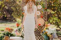 12 a boho lace sleeveless sheath wedding dress with a deep neckline paired with a neutral hat for a hippie feel