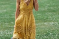 12 a yellow lace knee dress on thick straps, with a V-neckline, black strappy shoes and a wicker hat for a summer wedding