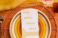 14 a bright wedding place setting with a woven charger, colorful plates, a bold menu, a yellow runner and some candles