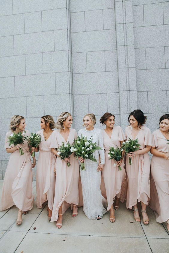 tender blush wrap maxi bridesmaid dresses with high low skirts, V necklines and short sleeves