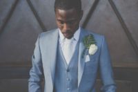 16 a formal groom’s look with a blue three-piece suit, a white shirt and a tie plus a whimsical boutonniere