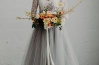 19 a chic bridal look with a grey tulle skirt and a white lace top with long sleeves for a modern romantic bride