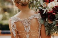 20 a fantastic lace mermaid wedding dress with a cutout back with chains and embellishments and a train