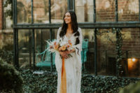 21 a lace wedding gown with bell sleeves and a V-neckline plus a train is a great idea for a 70s boho bridal look