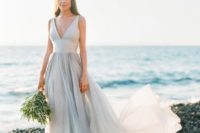 21 a modern bridal separate of a neutral top with a deep neckline and a layered skirt with a train