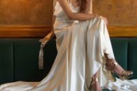 22 a neutral lace spaghetti strap wedding dress paired with metallic shoes and accessories for a boho look