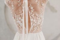 22 a romantic wedding gown with illusion lace back with a slight cutout and a bow and a flowy plain skirt