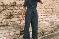 23 a polka dot jumpsuit with cropped pants, short sleeves, neutral platform shoes and a small matching bag