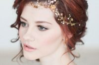 23 a romantic yet bold red hair updo with a gold and white hair vine on the side