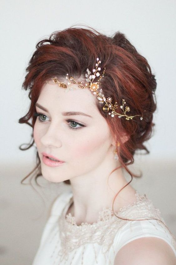 a romantic yet bold red hair updo with a gold and white hair vine on the side