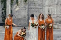bridesmaids in rust colored jumpsuits looks great during fall season