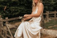 24 a silk spaghetti strap wedding dress with neutral cowboy boots and a neutral hat for a boho rustic bridal look