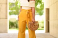 24 high waisted yellow pants, a creamy off the shoulder top, a straw bag and statement earrings