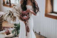 26 an off the shoulder lace mermaid wedding dress with a long train for a boho chic wedding look
