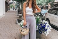 26 slate grey cropped wideleg pants, a white silk top with lace, nude heels and a wicker bag for a casual summer wedding