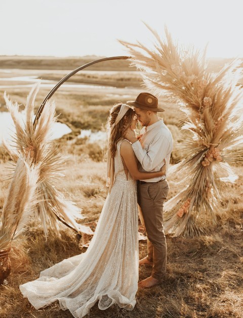 The arch with dried flowers and herbs is the perfect idea for a Moroccan or boho-inspired wedding like this one