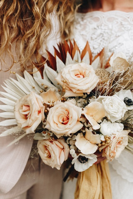 The wedding bouquet was very gentle with pastel colored roses, dried flowers and a linen ribbon