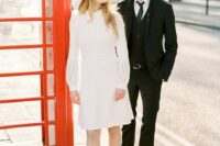a 70s inspired knee wedding dress with a high neckline, long sleeves, a matching hat and plaid booties