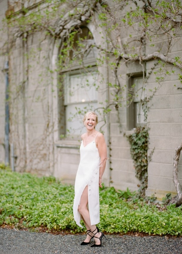 a beautiful and chic wedding dress - a midi slip dress decorated with buttons that create a slit, black strappy heels