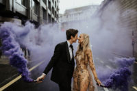 a beautiful wedding portrait with purple smoke bombs create an impression that there’s nobody else here