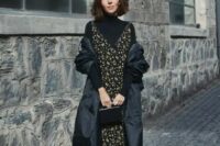 a black turtleneck, a moody floral midi dress over it, sock boots, a small bag and a puff midi coat