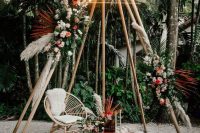 a boho wedding altar of neutral and pink blooms, greenery pampas grass, a neon sign on top is a cool idea