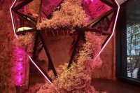 a breathtaking wedding backdrop of a large neon sign, pink mirror, pink baby’s breath is an amazing idea